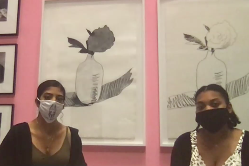 A screenshot from a Zoom presentation by two students in front of a pink wall and artwork by Andy Warhol