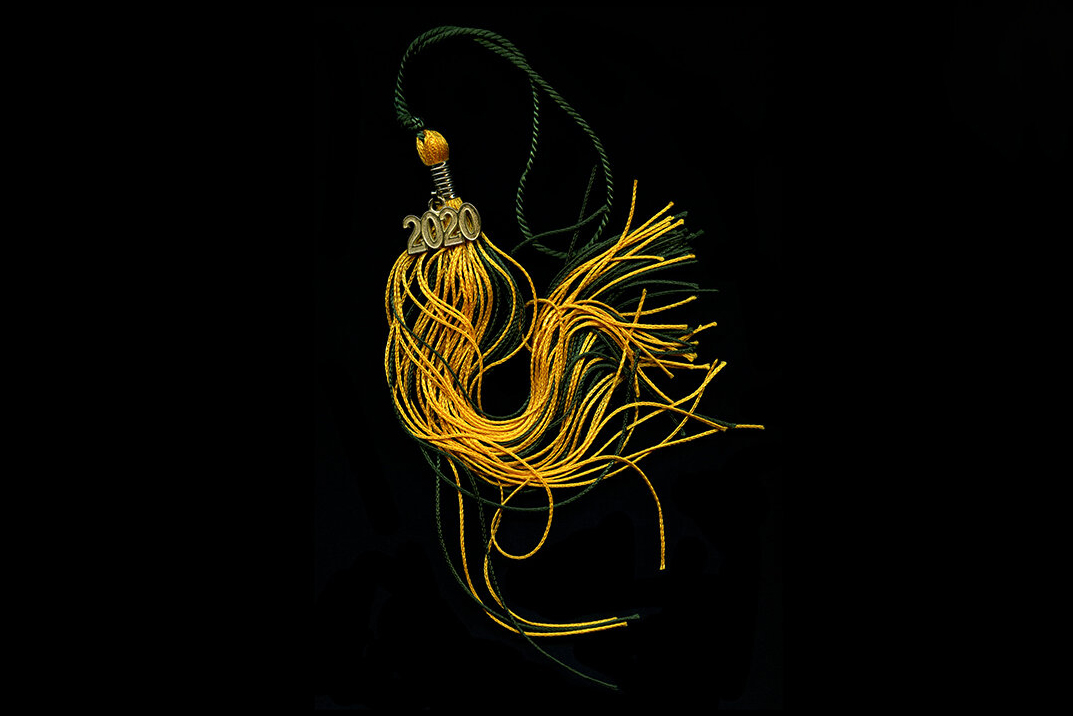 A green and gold tassle with a 2020 pin on the top